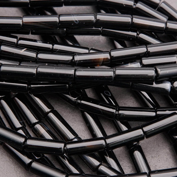 Close-up of black metal tubes stacked together