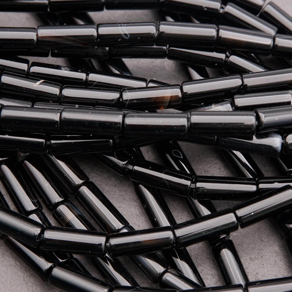 Close-up of black metal tubes stacked together