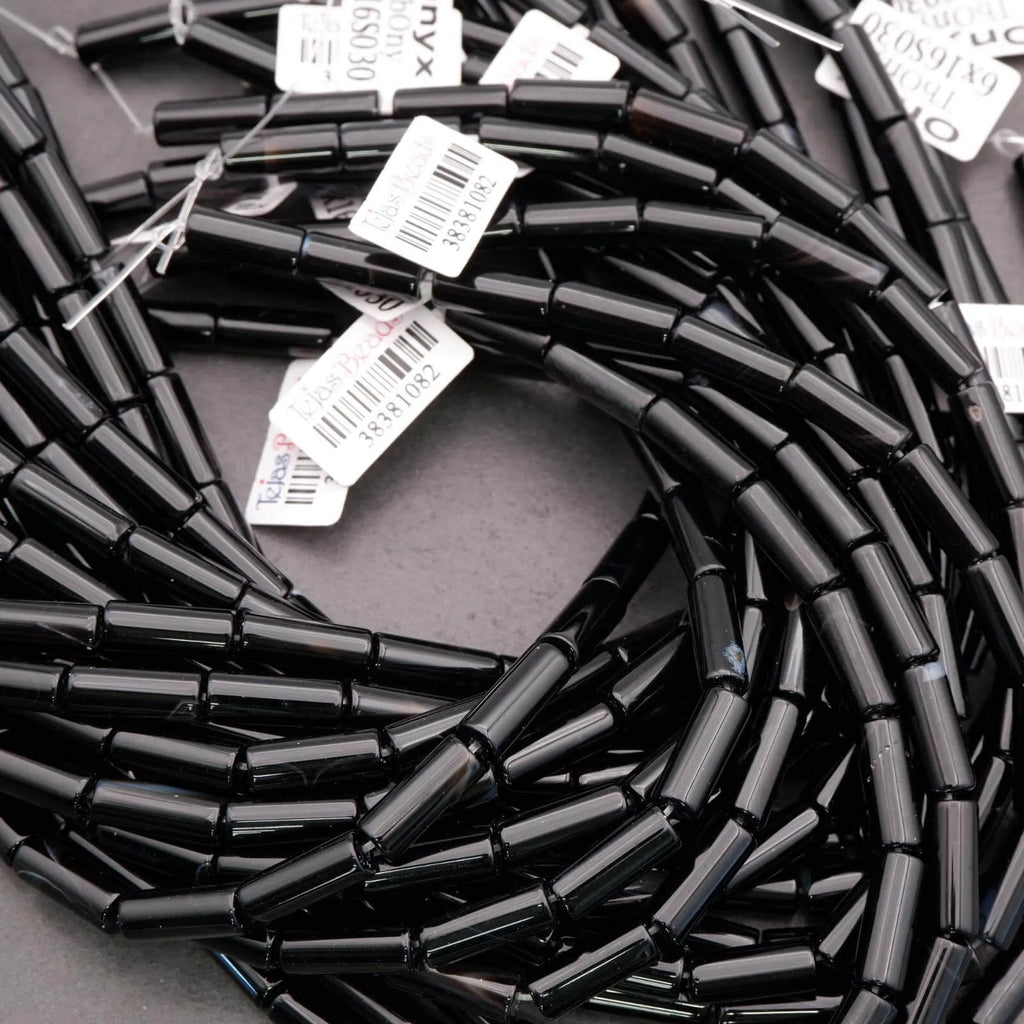 Coiled black cable with barcodes on a dark surface