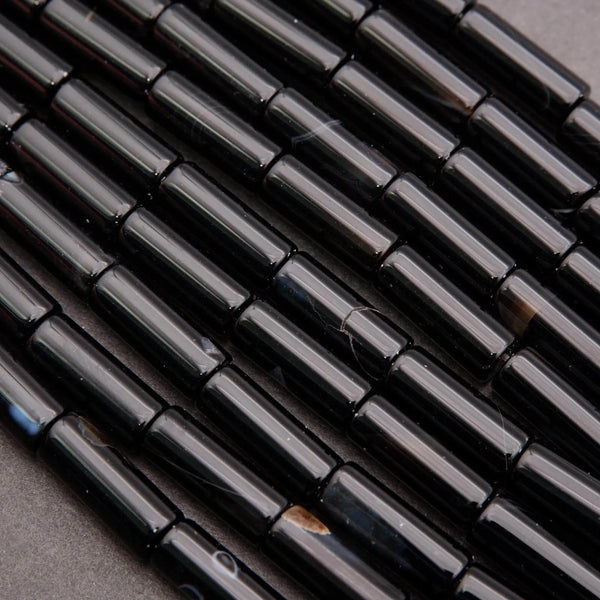 Close-up of black cylindrical objects on a gray surface