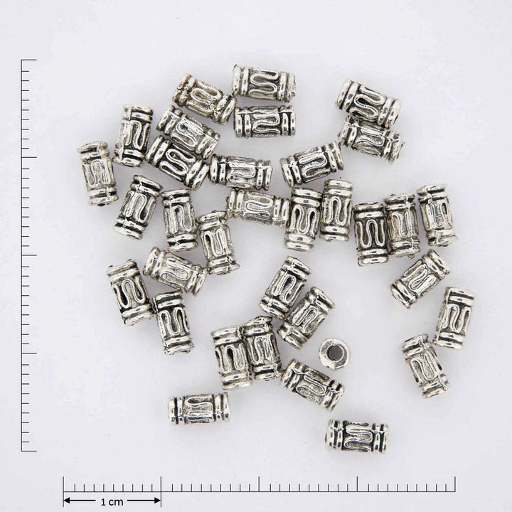 Silver plated jewelry finding tube beads with squiggly patterns.