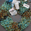 Multicolored beaded strands with tags on a gray background