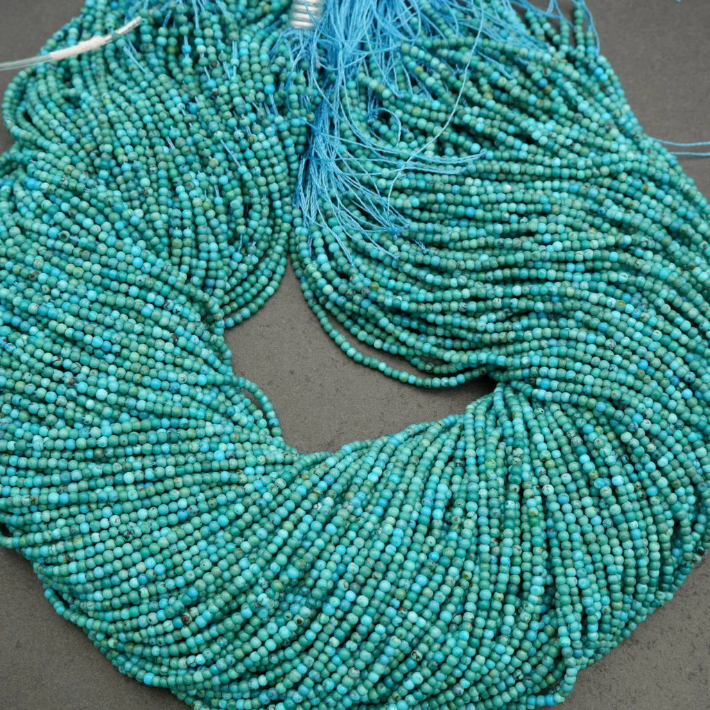 Turquoise beads strung together on a gray surface
