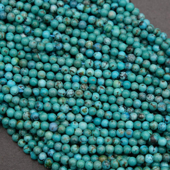 Close-up of turquoise beads on a dark surface