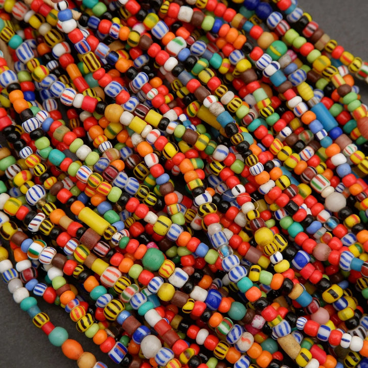 Close-up of colorful beads in various sizes and patterns on a dark background