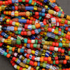 Close-up of colorful glass beads in various shapes and sizes.