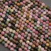 Close-up of multicolored round beads on a gray background