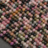 Close-up of multicolored beads on a dark surface