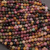 Close-up of multicolored gemstone beads on a dark background
