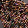 Close-up of multicolored gemstone beads on a gray background