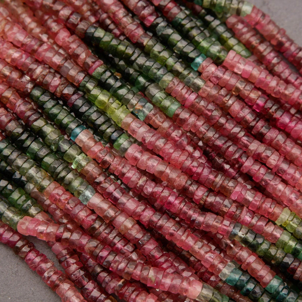 Close-up of multicolored gemstone beads on a gray background