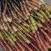 Close-up of multicolored bead strands on a gray background