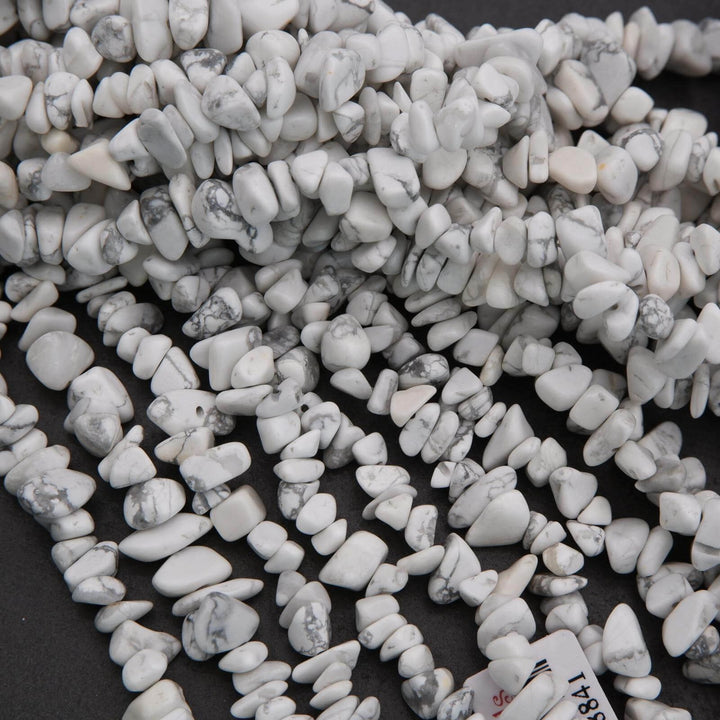 Close-up of small white stones on a dark background
