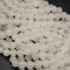 Faceted white jade beads.