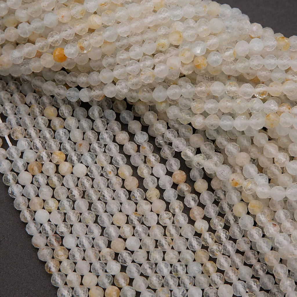 Close-up of white and beige beads on a dark background