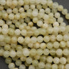 Yellowish green beads with subtle banding.