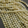 Yellowish green beads with subtle banding.