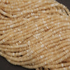 Close-up of a string of beige beads on a dark background