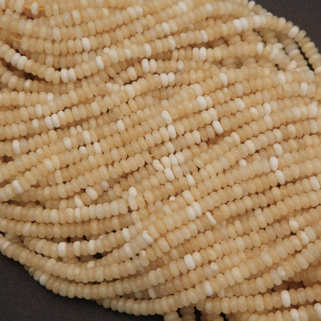 Close-up of a string of beige beads on a dark background