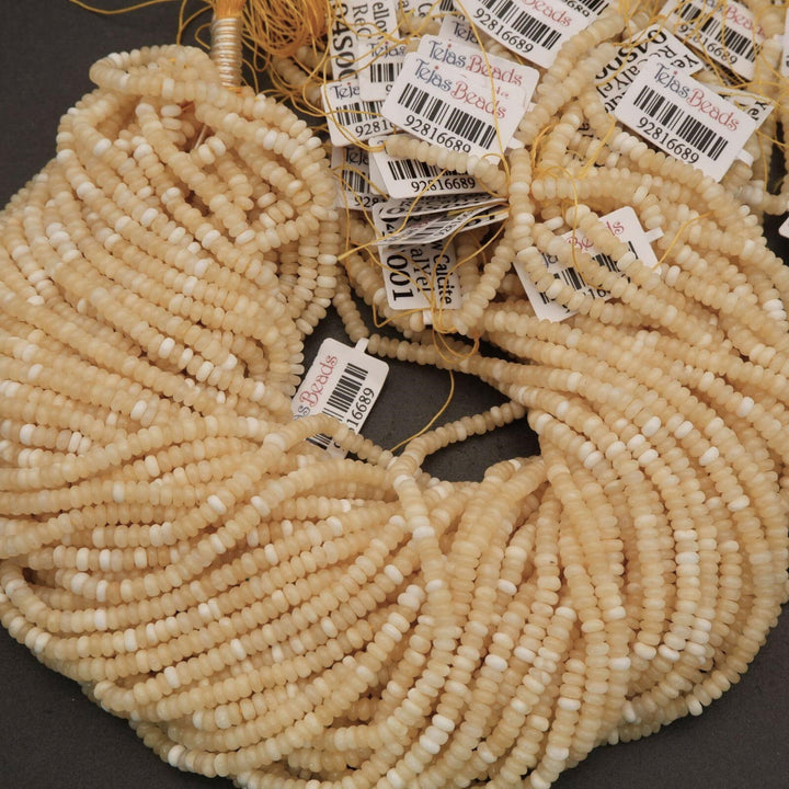 Close-up of beige beads with barcodes on a dark surface