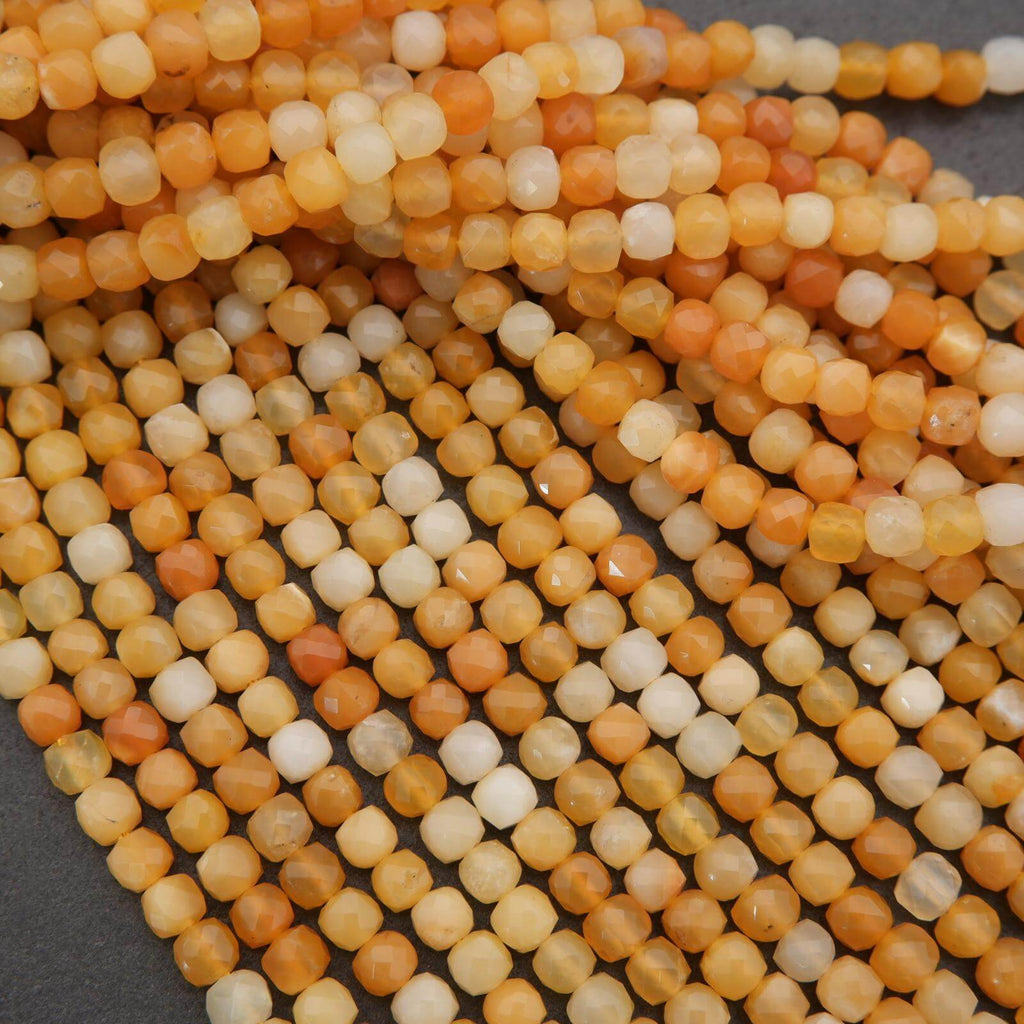 Close-up of orange and white beads on a dark background