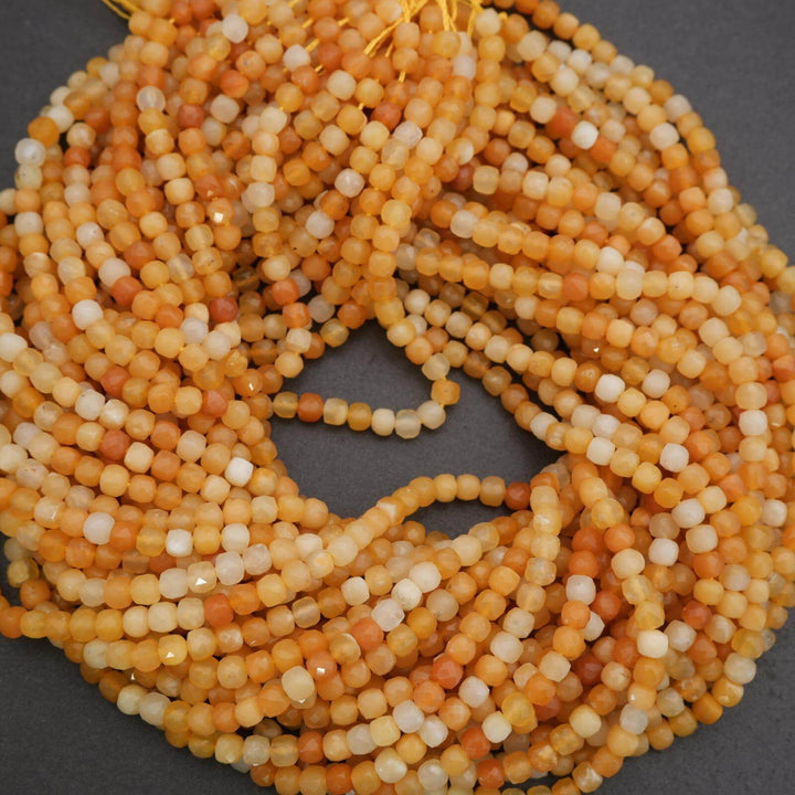 Close-up of a string of orange and white beads on a dark background
