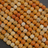 Close-up of orange and white beads on a dark background