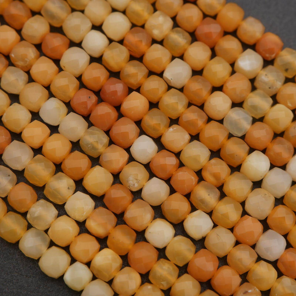 Close-up of orange and white beads on a dark background