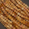 Close-up of heart-shaped beads in various shades of brown and beige.