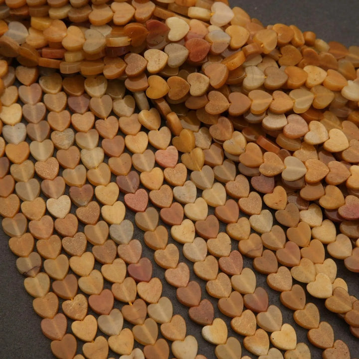 Close-up of heart-shaped beads in various shades of brown and orange.