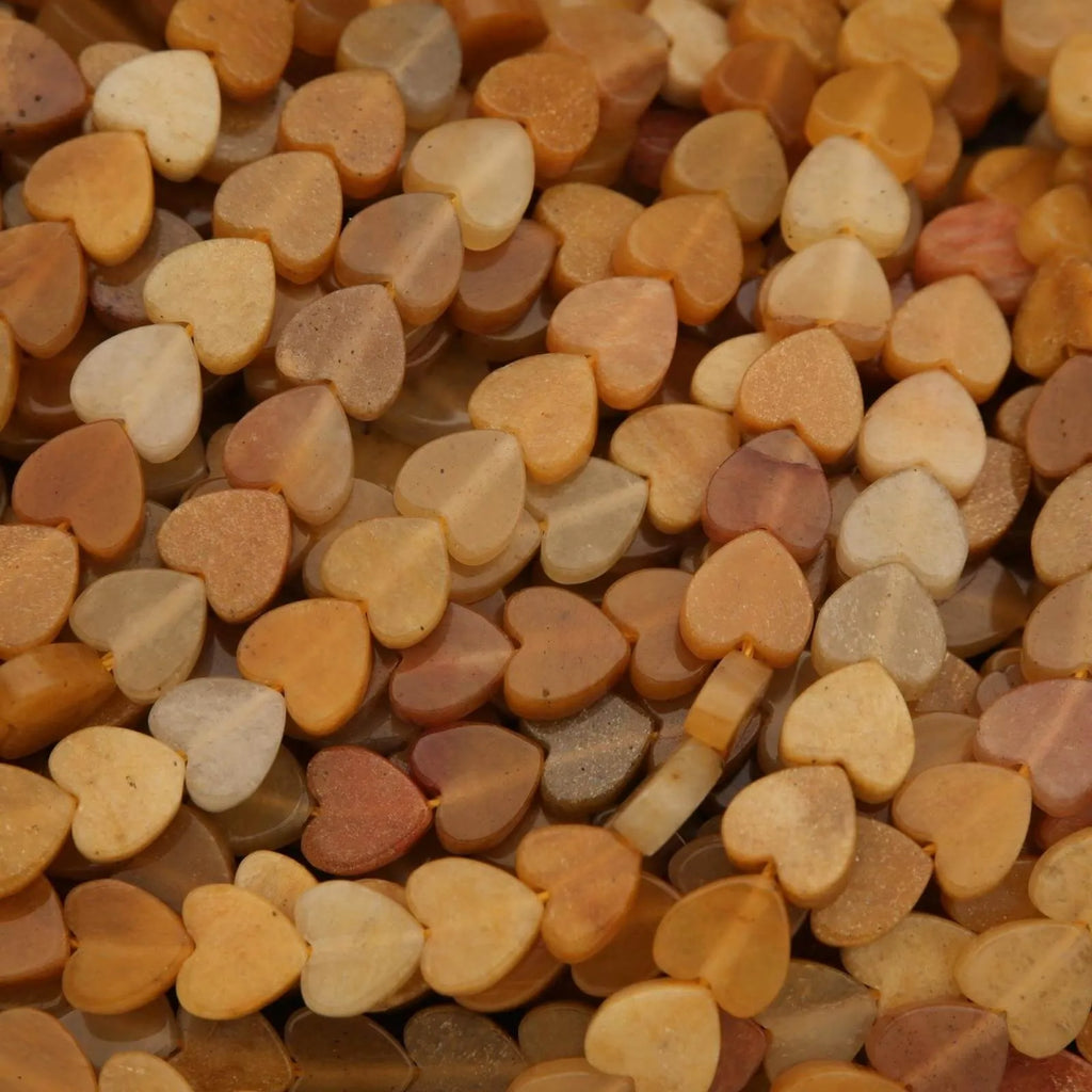 Close-up of heart-shaped stones in various shades of brown and beige.