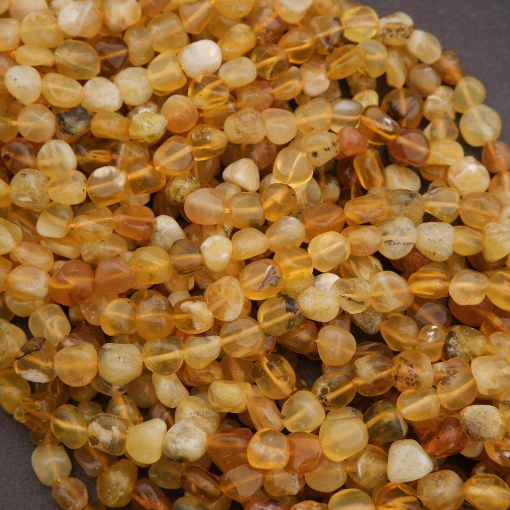 Close-up of amber-colored beads on a gray background