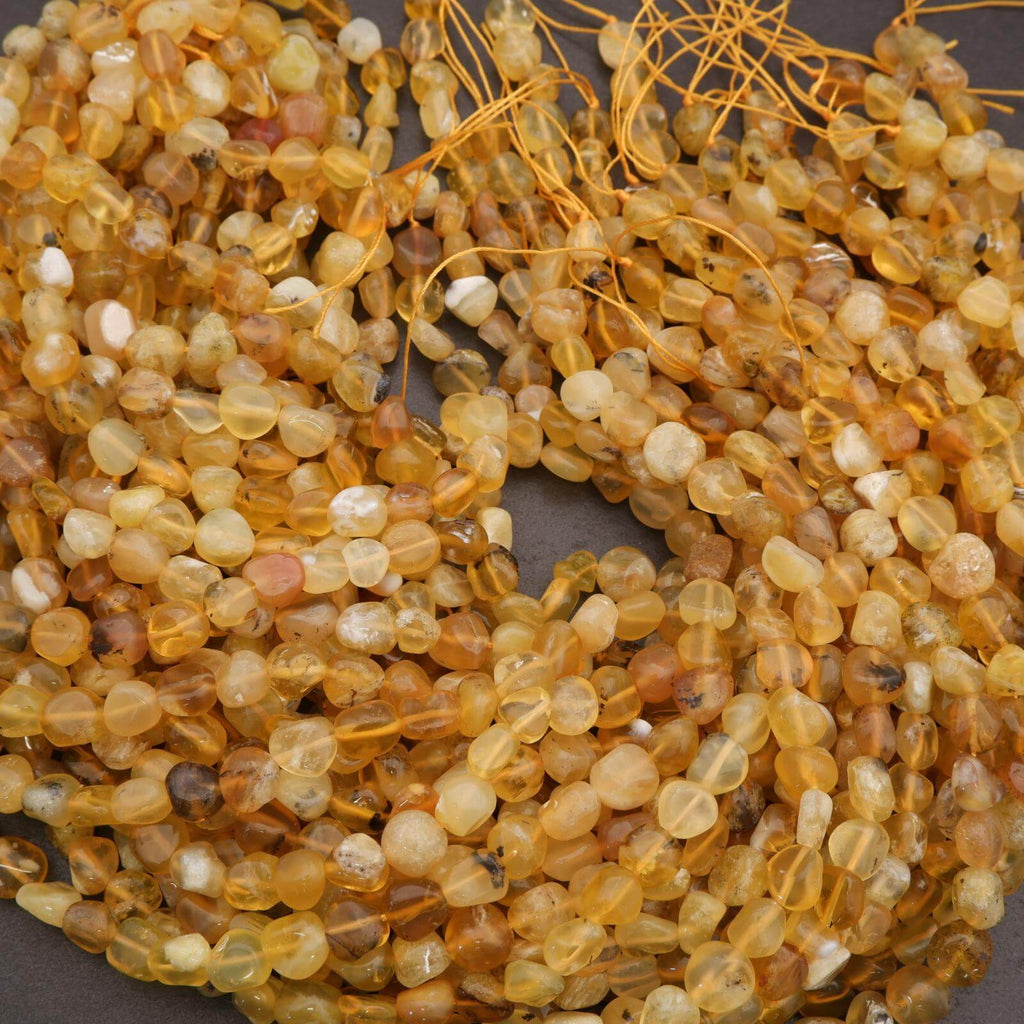 Close-up of amber-colored beads on a string against a dark background
