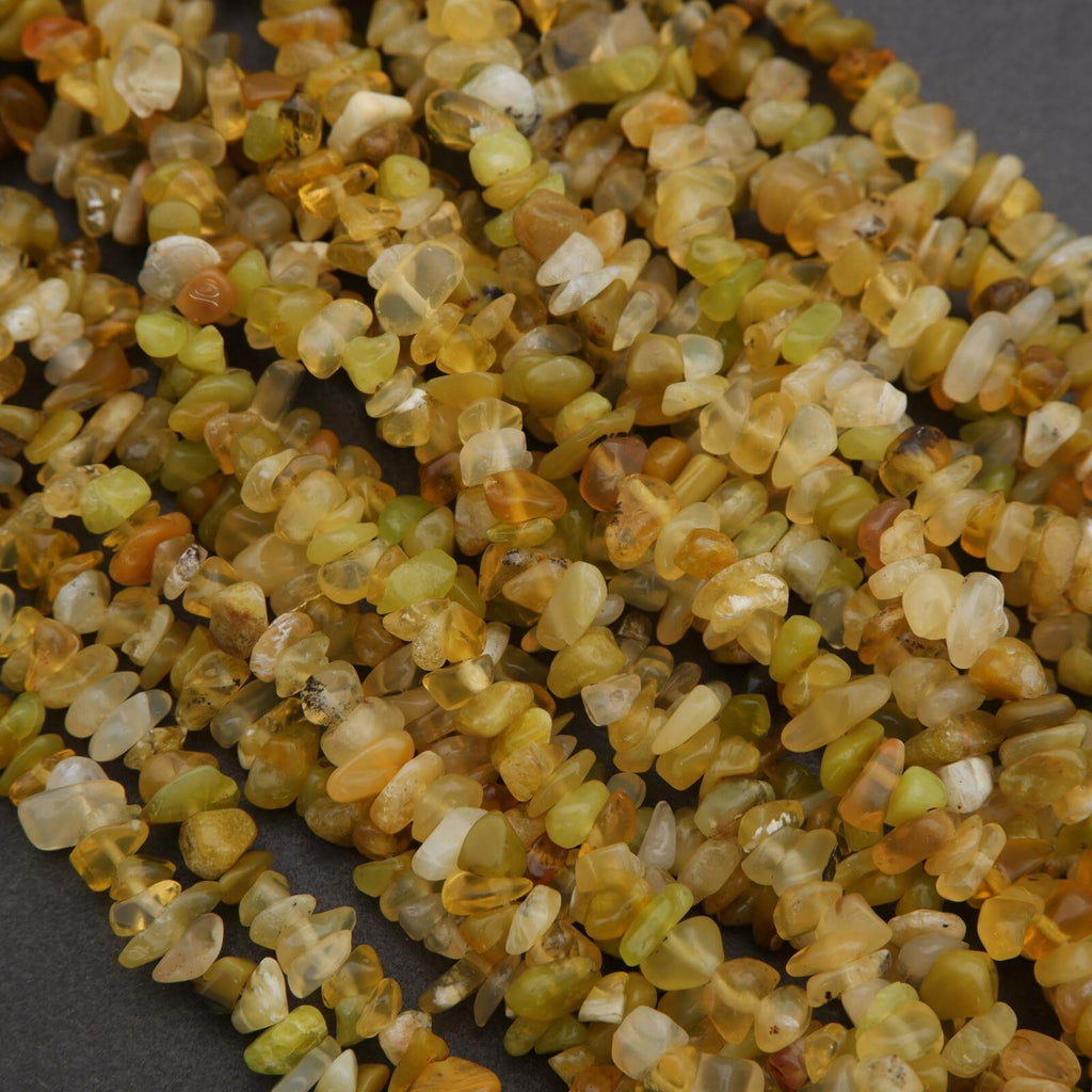 Close-up of a string of small, multicolored stones on a dark background
