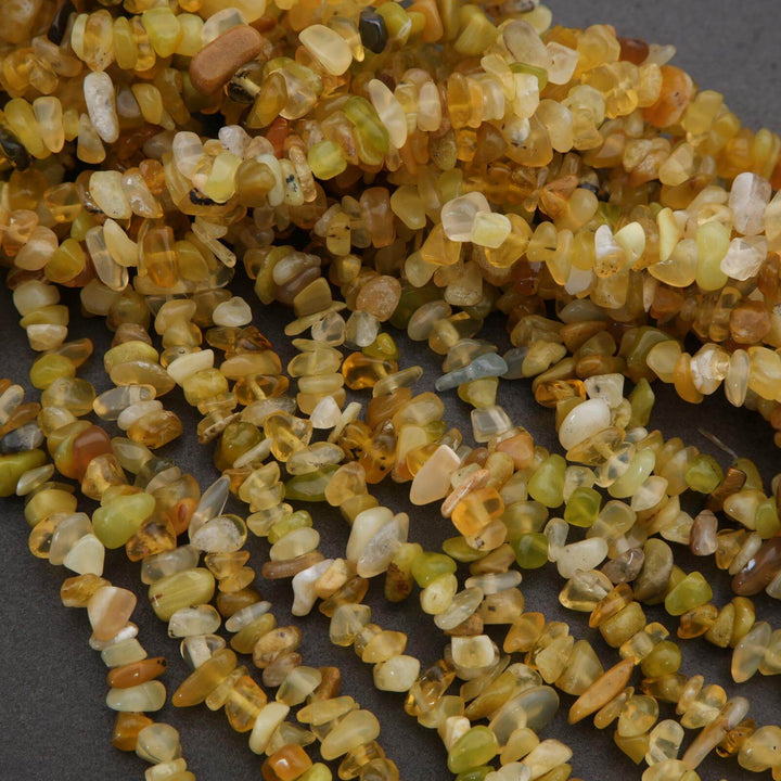 Close-up of a string of small, multicolored stones on a dark background