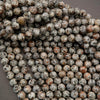 Close-up of round, textured beads on a gray background