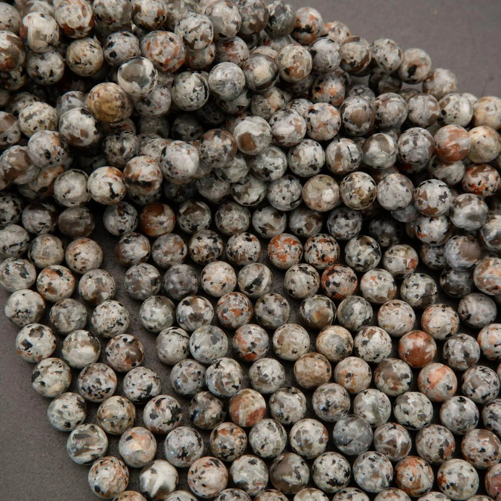 Close-up of round, textured beads on a gray background