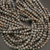 Close-up of a string of round beads with a gray background