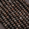 Strands of Yooperlite rondelle beads laid flat