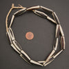 Black and white elongate tube bone beads.