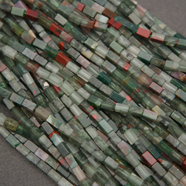 African bloodstone rectangular beads featuring forest green, smoky gray, and deep red mineral patterns.