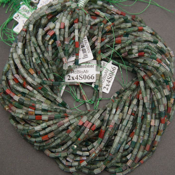 Close-up of African bloodstone beads displaying earthy green coloration and distinctive red inclusions.