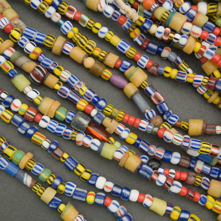 Close-up of colorful glass beads on a gray surface