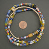 Colorful beaded necklace on a gray background with a penny for scale