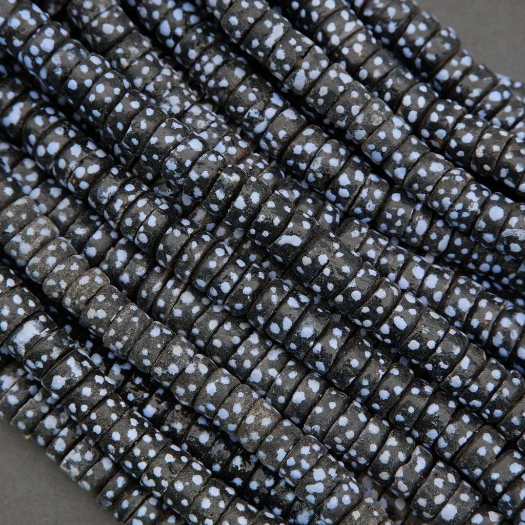 Close-up of dark fabric with white speckles on a gray background