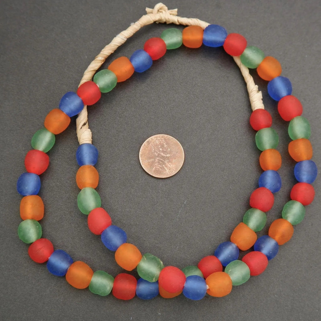 Colorful beaded necklace with a coin for size comparison on a gray background