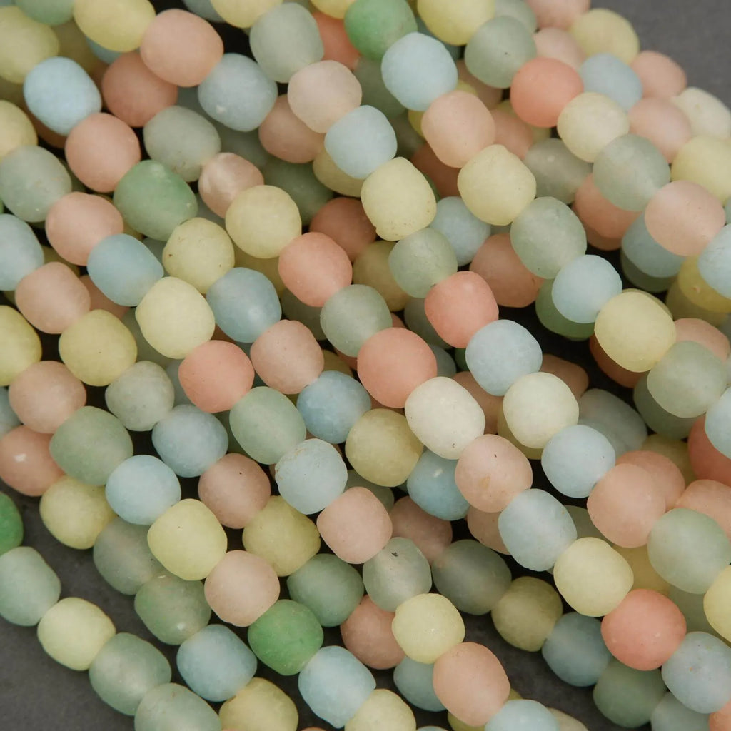 Close-up of pastel-colored beads on a dark background