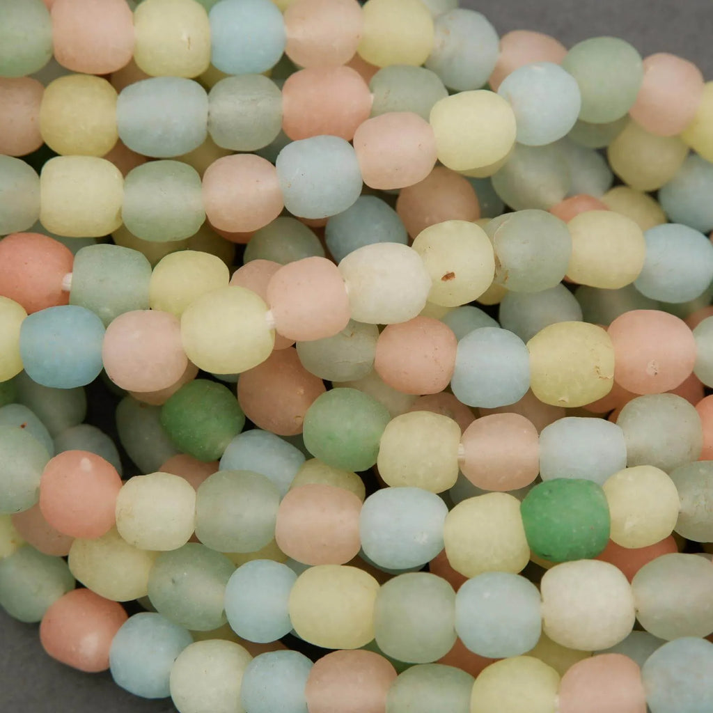 Close-up of pastel-colored beads on a gray background
