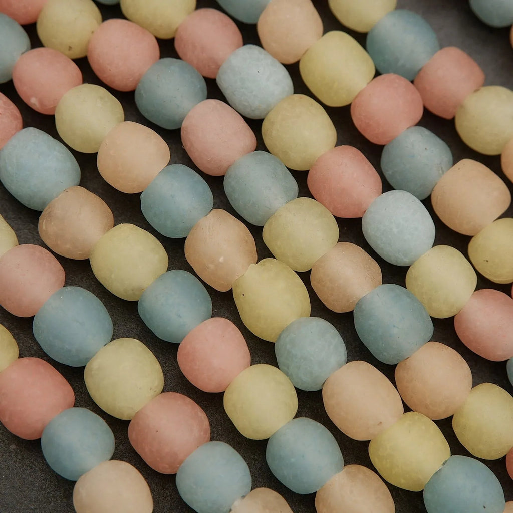 Close-up of pastel-colored round beads on a dark surface