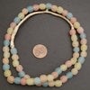 Necklace with pastel-colored beads on a dark gray background, next to a penny for size reference.
